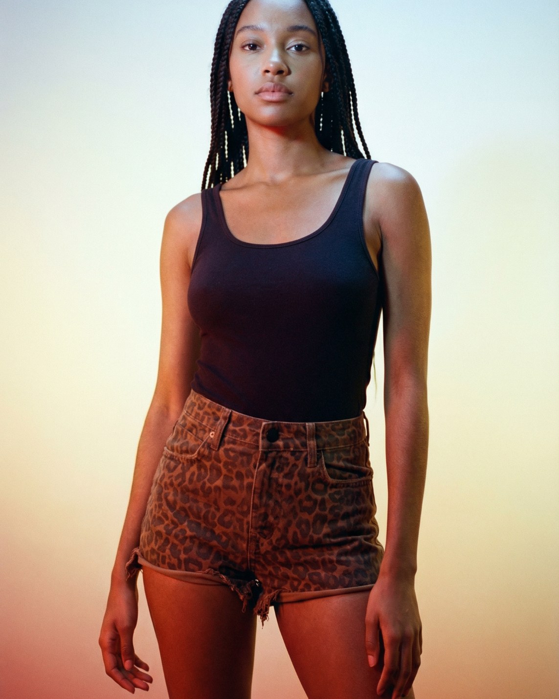 Model wearing Alexander Wang ‘Bite’ leopard-print high-waisted cutoff denim shorts with raw frayed hem